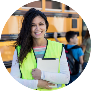  woman holding clipboard in front of school bus